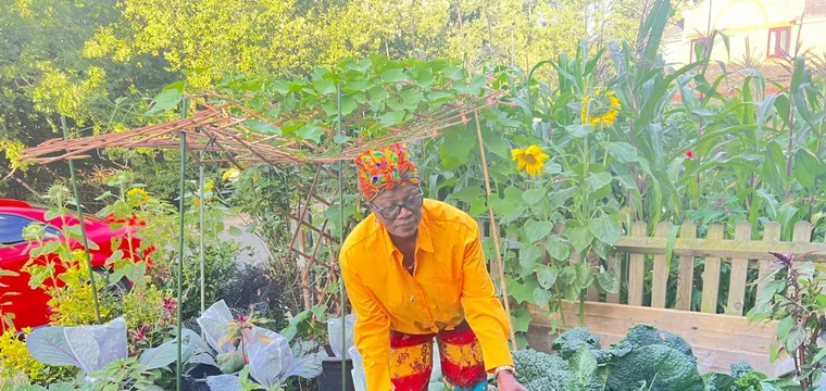 Donna tending her thriving garden
